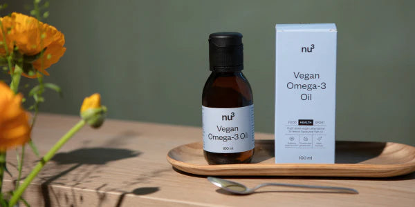 Huile d'oméga-3 vegan de nu3 avec une cuillère